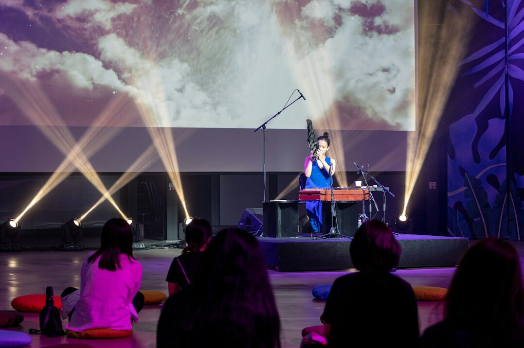 Speaker presenting on stage to an audience