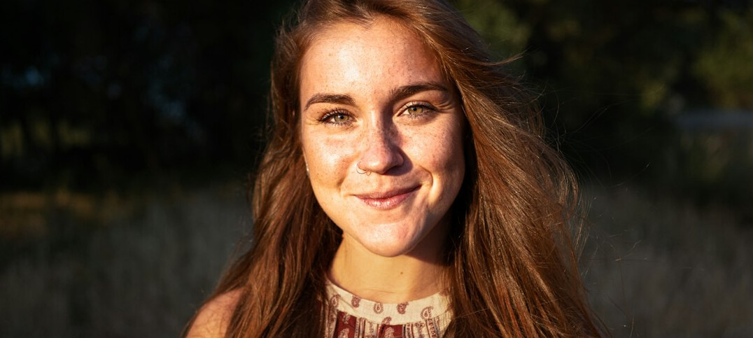 Portrait of a woman with long brown hair smiling