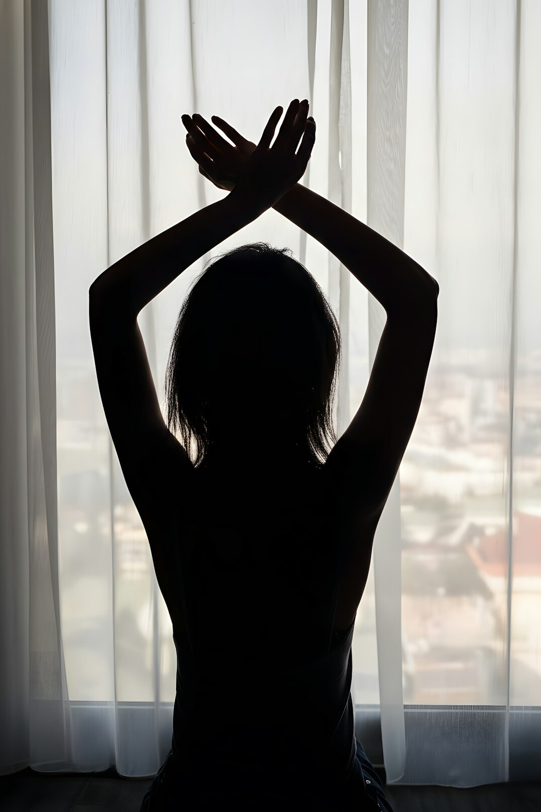 Woman meditating calmly near a window